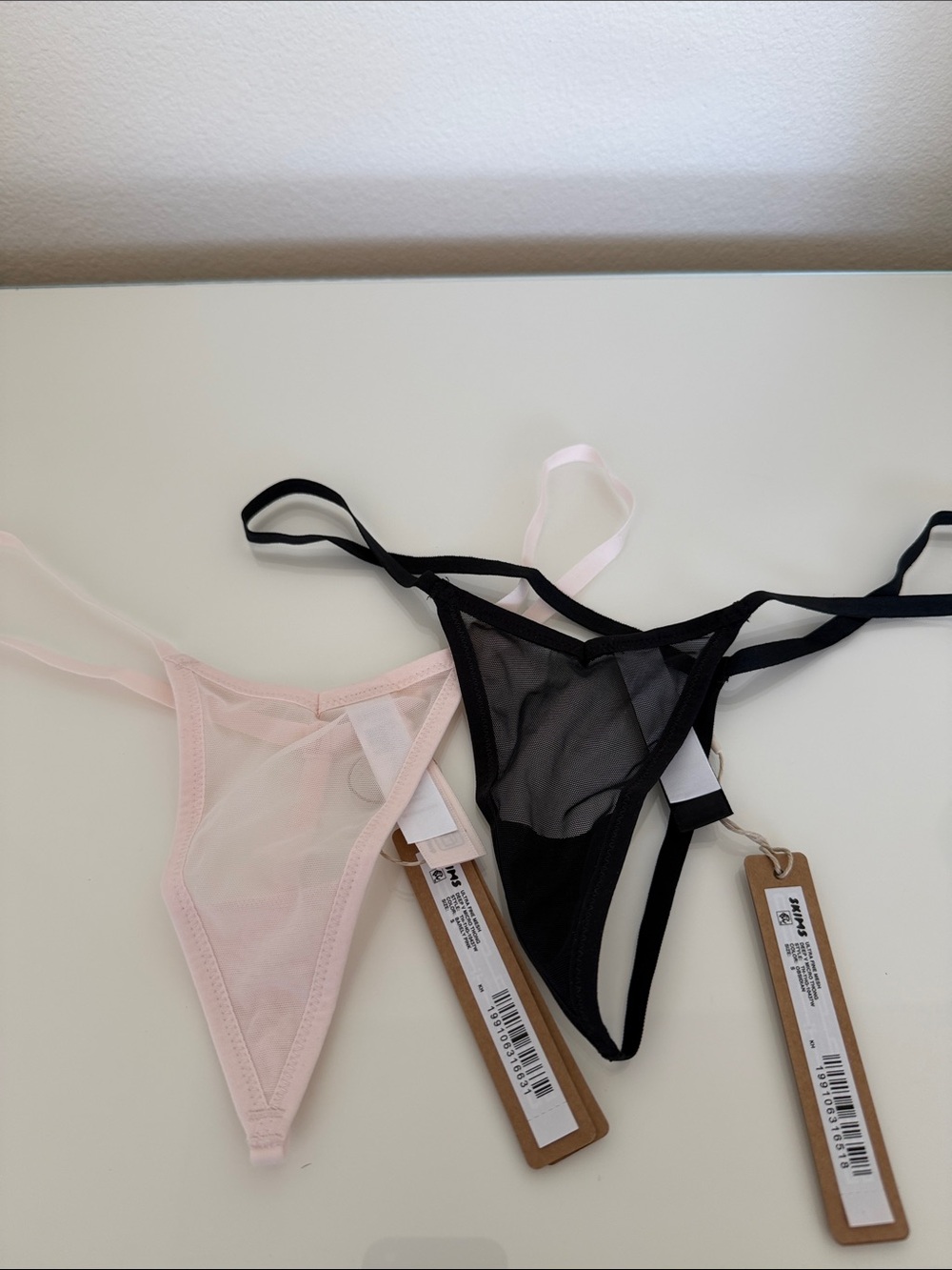 SKIMS Sheer Mesh Thong Panty in Black and Light Pink